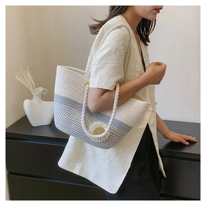 Detail of flower woven tote bag with grey and white daisy design and rope handles