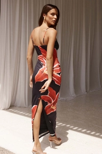Detail of floral print maxi dress featuring backless design and stylish back slit detail