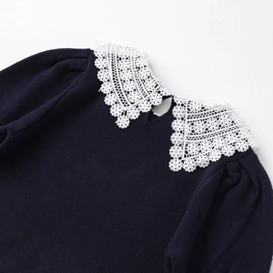 Navy knit sweater featuring an elegant white lace crochet collar and puff sleeve detail