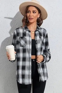 Detail view of black and white plaid flannel shirt with a functional front chest pocket
