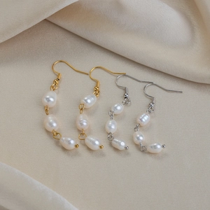 Baroque freshwater pearl drop earrings in 18K gold and silver finishes on silk fabric