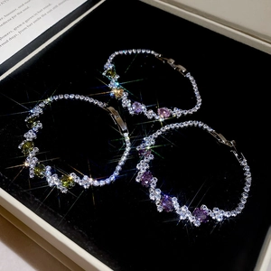 Macro shot of silver plated tennis bracelets with sparkling zircons and colored gemstones