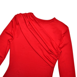 Detailed close-up of the elegant diagonal pleated design on a red long sleeve dress