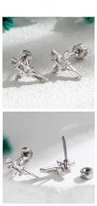 Macro detail of silver sword cross studs with zircon and screw back closure