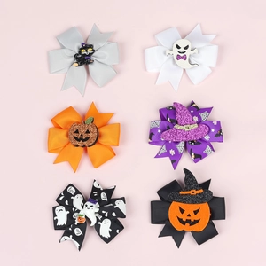 Detail of six Halloween bow hair clips with glitter ghosts, pumpkins and witch hats