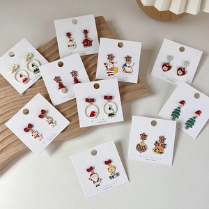 Christmas themed earring set featuring Santa, reindeer and tree designs in colorful enamel