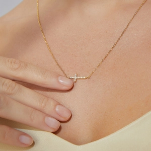 Elegant gold cross necklace for women featuring shimmering zircon stones on an O-chain