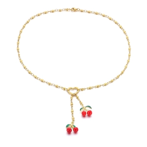 Golden bead necklace with red cherry pendants and heart link on white background