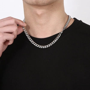 Minimalist silver stainless steel cuban link chain necklace worn by a male model