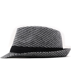 Detailed close-up of classic black and white houndstooth wool felt fedora with black band
