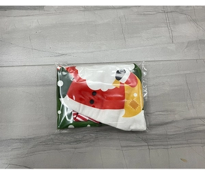 Close-up of a Santa Claus patterned Christmas stocking in transparent plastic packaging