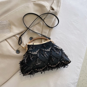 Detail of elegant black sequin evening bag with metal clasp and bead embroidery