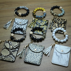 Close-up of silicone bead bracelets with animal print wallets and tassel keychains