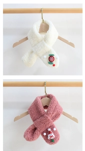 Detail of plush children's scarves with candy and snowman decorations in white and pink