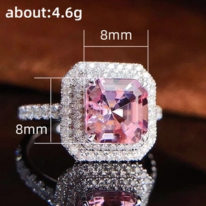 Macro detail of luxury ring with 8mm pink emerald-cut zircon and double halo diamonds