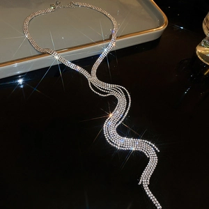 Macro shot of silver multi-layer tassel necklace with rhinestones on a tray