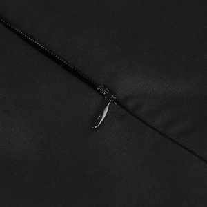 Detail shot of a black invisible zipper on premium woven polyester evening dress fabric