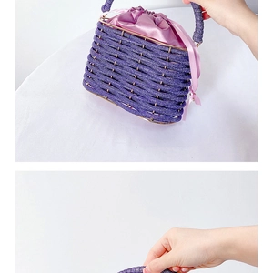 Detail of purple beaded bucket bag with drawstring satin lining and woven top handle