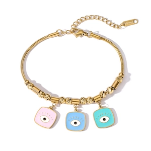 Detail of gold snake chain bracelet with three colorful enamel evil eye charms