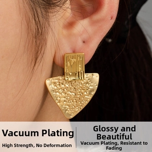 Detailed close-up of gold plated geometric earrings featuring vertical and hammered textures