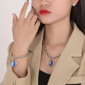 Close-up of heart-shaped blue crystal jewelry set with OT toggle clasp and silver chains