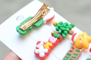 Close-up of colorful Christmas tree and Xmas letter hair clips with soft rubber textures