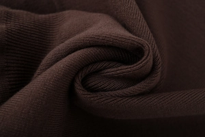 Detail shot of deep brown ribbed knit fabric with soft texture and elastic weave