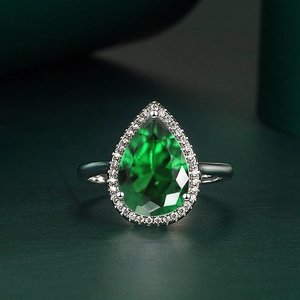 Elegant pear-cut emerald gemstone ring with white zircon halo and silver band