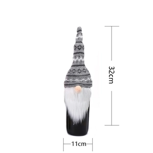 Detail view of knitted gnome wine bottle cover with 32cm height and 11cm width specs