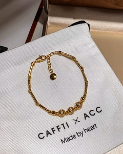 Detailed view of 18K gold plated bamboo link bracelet with zircon hollow beads