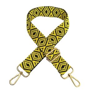 Detail of adjustable 3.8cm yellow and black geometric embroidery strap with gold hardware