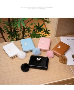 Mini leather coin purses with fluffy pompoms and golden butterfly details in five colors