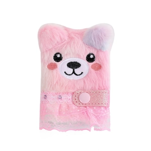 Detail of pink plush bear notebook with lace trim and soft embroidery texture
