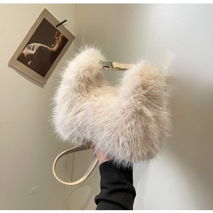 Close-up of beige faux fur crossbody bag with metal buckle and soft plush texture