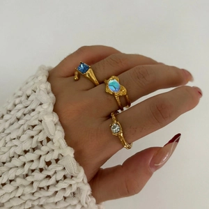 Three-piece gold stainless steel ring set with irregular textures and colorful stones