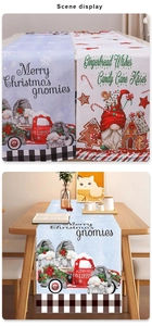 Detail of Christmas gnomes linen table runner with red truck and festive scene display