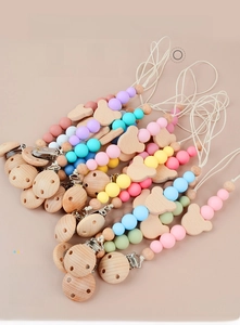 Detail of colorful silicone beads and wooden bear pacifier clips for sensory training
