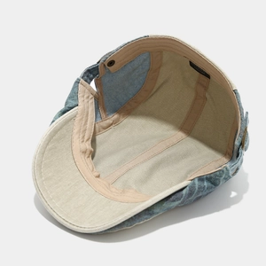 Detail of 100% cotton blue denim hat interior with stitched lining and size label