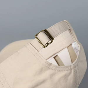Macro detail of washed cotton baseball cap with adjustable antique bronze metal buckle