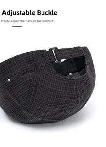 Detail of grey plaid baseball cap with adjustable black buckle for personalized fit