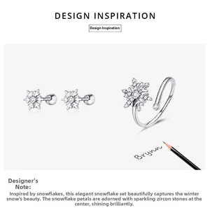 Macro view of silver snowflake jewelry set with cubic zirconia earrings and open ring