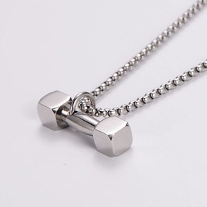 Close-up of polished stainless steel dumbbell pendant on a round pearl chain necklace
