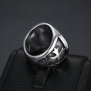 Detailed close-up of retro Saint Michael stainless steel ring on black leather display