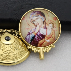 Macro detail of golden Orthodox metal icon featuring Mother Mary and Jesus with base