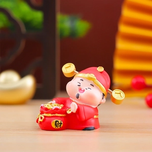 Close-up of cute cartoon God of Wealth figurine holding a red Fortune bag