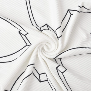 Macro detail of white ribbed dress fabric with geometric black 3D line print textures