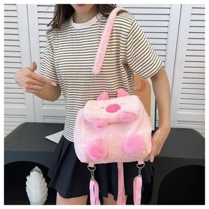 Detailed close-up of pink plush pig cartoon bag with adjustable strap and chain link