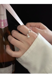 Detail shot of a 925 sterling silver heart ring with pearl pendant on finger