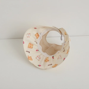Detail of breathable mesh lining and cute cartoon bear print on a beige sun visor hat