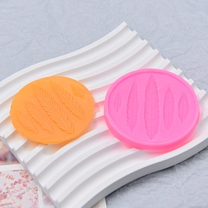Two-piece angel feather silicone mold set in pink and orange for DIY cake baking